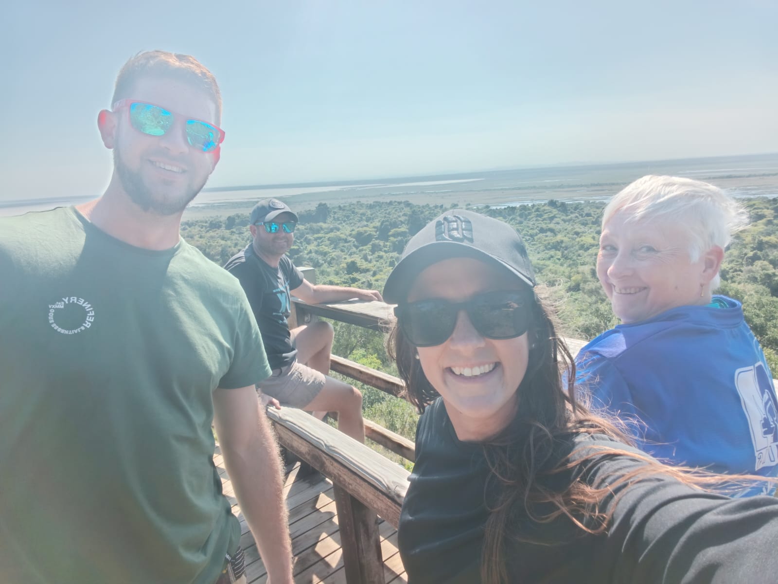 Angelo and friends taking a selfie at a wooden lookout over the wetlands