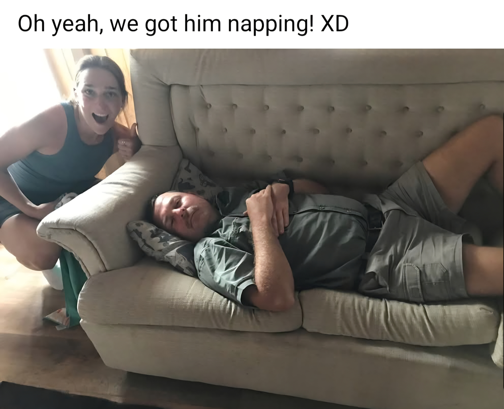 Angelo asleep on a sofa in his work clothes while a colleague smiles beside him, with the original playful Facebook message above