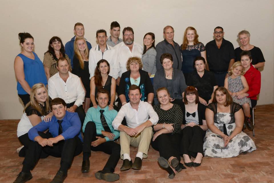 A large extended family group portrait of about twenty-five people