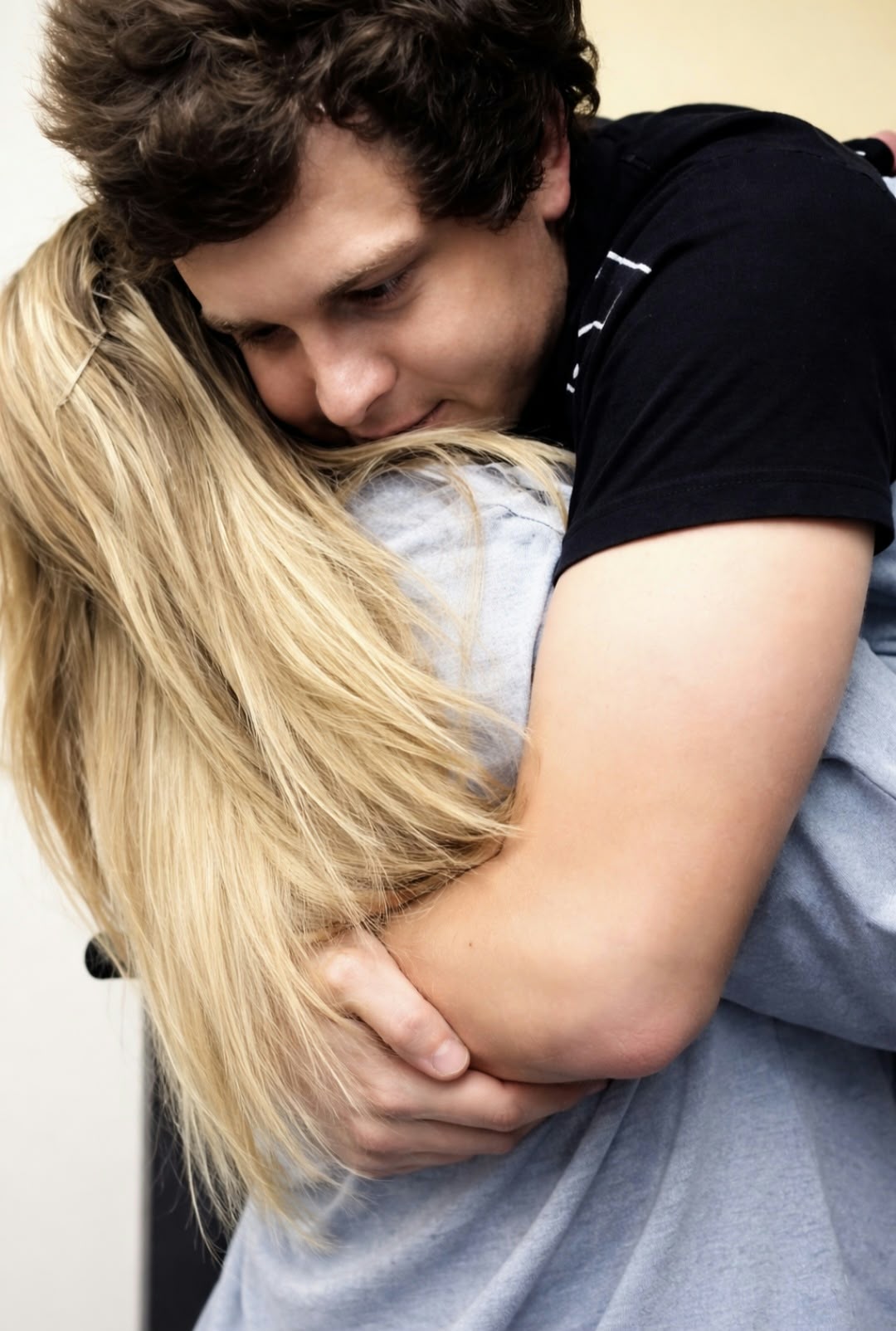 Angelo holding his sister Anysha in a tight, loving hug, his cheek resting on her shoulder
