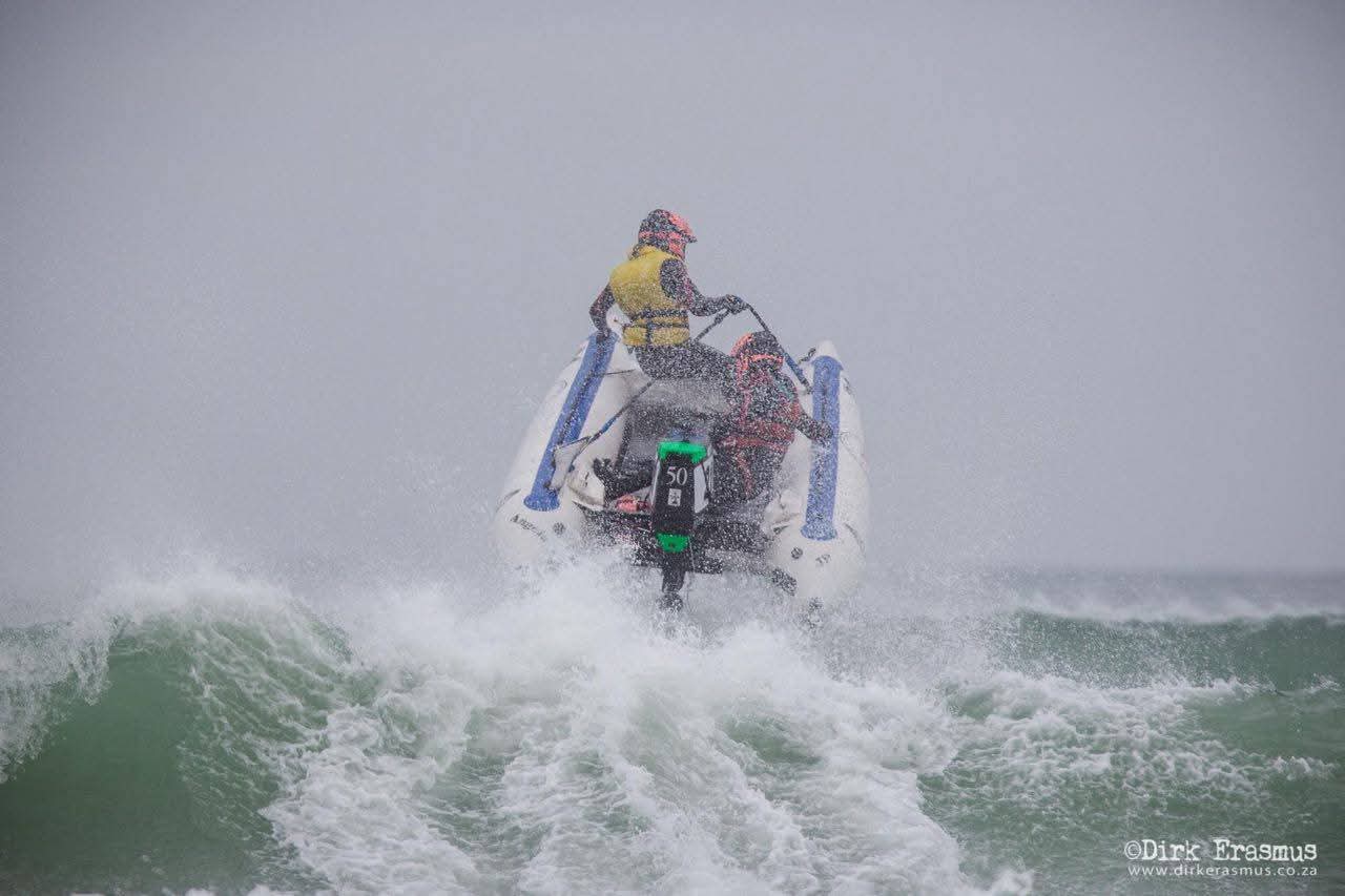 Angelo powering an inflatable racing boat through heavy surf