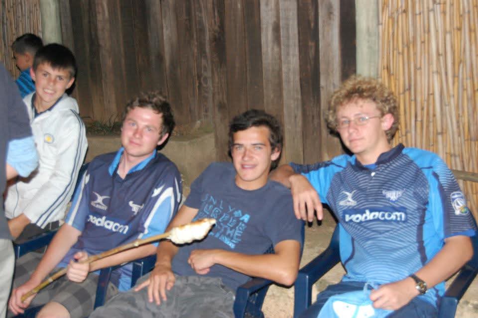 Angelo and friends roasting marshmallows at a night camp