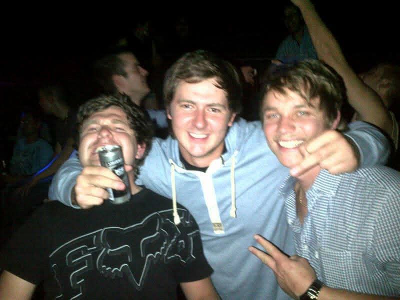 Three friends laughing together on a night out