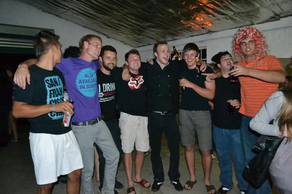 A line of friends standing arm in arm at the party