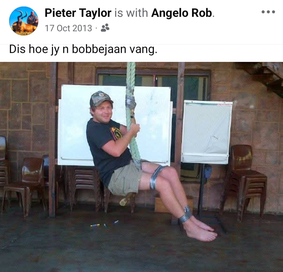 Angelo swinging on a thick rope swing inside a brick lapa hall