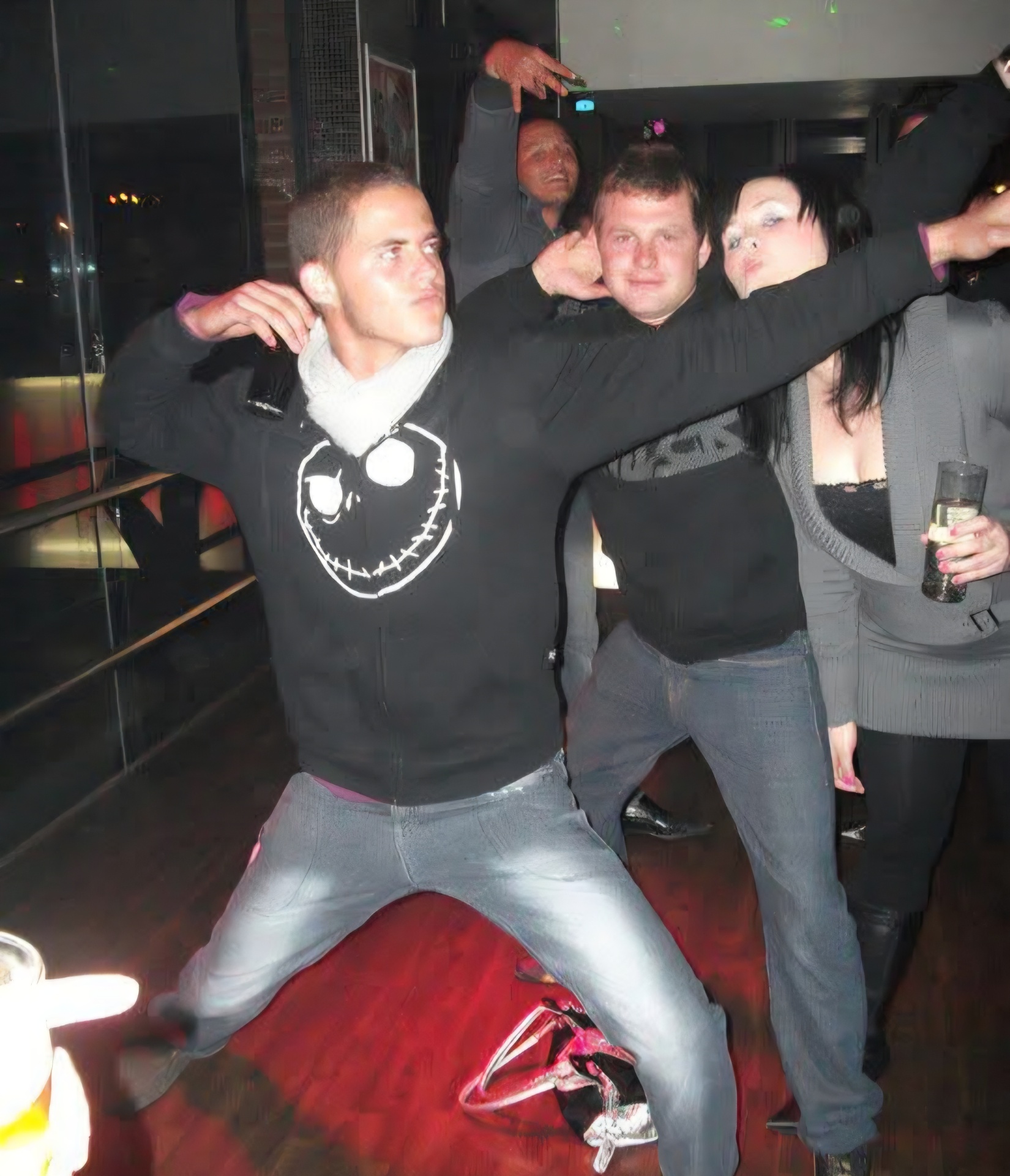 Angelo dancing in a black jacket at a club