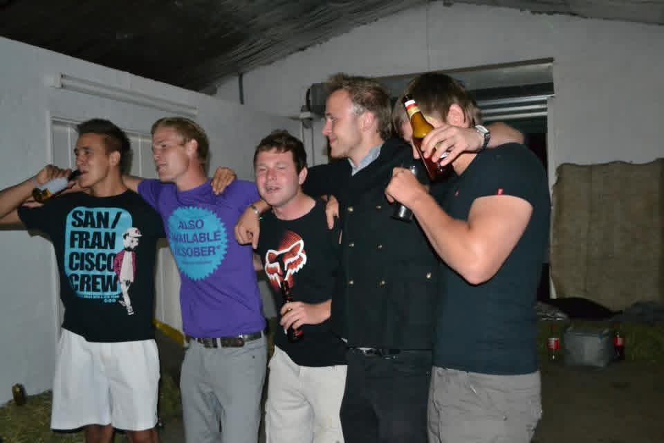 Five friends singing together with drinks at the party
