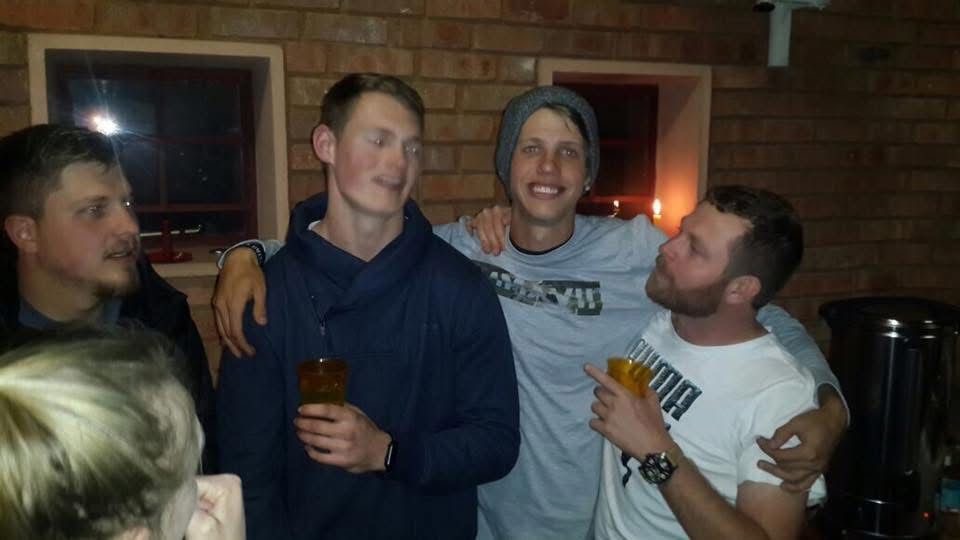 Angelo with his arms around family members at night