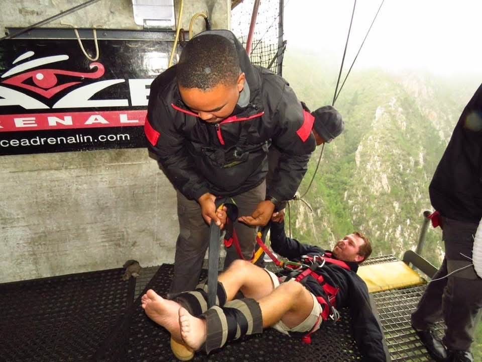 Angelo bending down to hold the strap of a jumper laid out on the Face Adrenalin platform