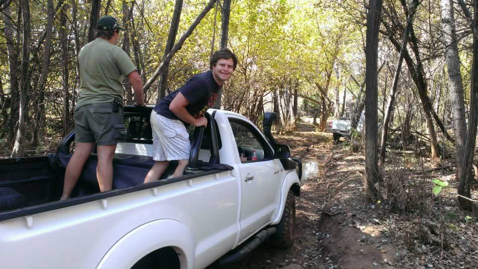 Friends riding through the trees in a white bakkie