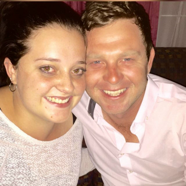 Angelo and a family member smiling together in a close selfie at night