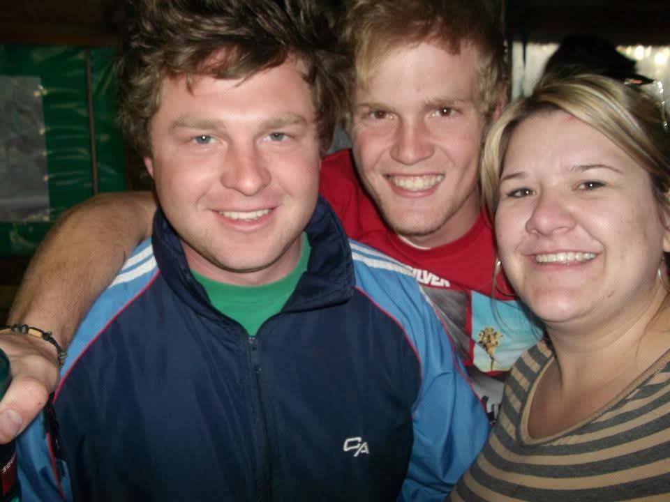 Angelo and two smiling friends posing for a selfie at a party