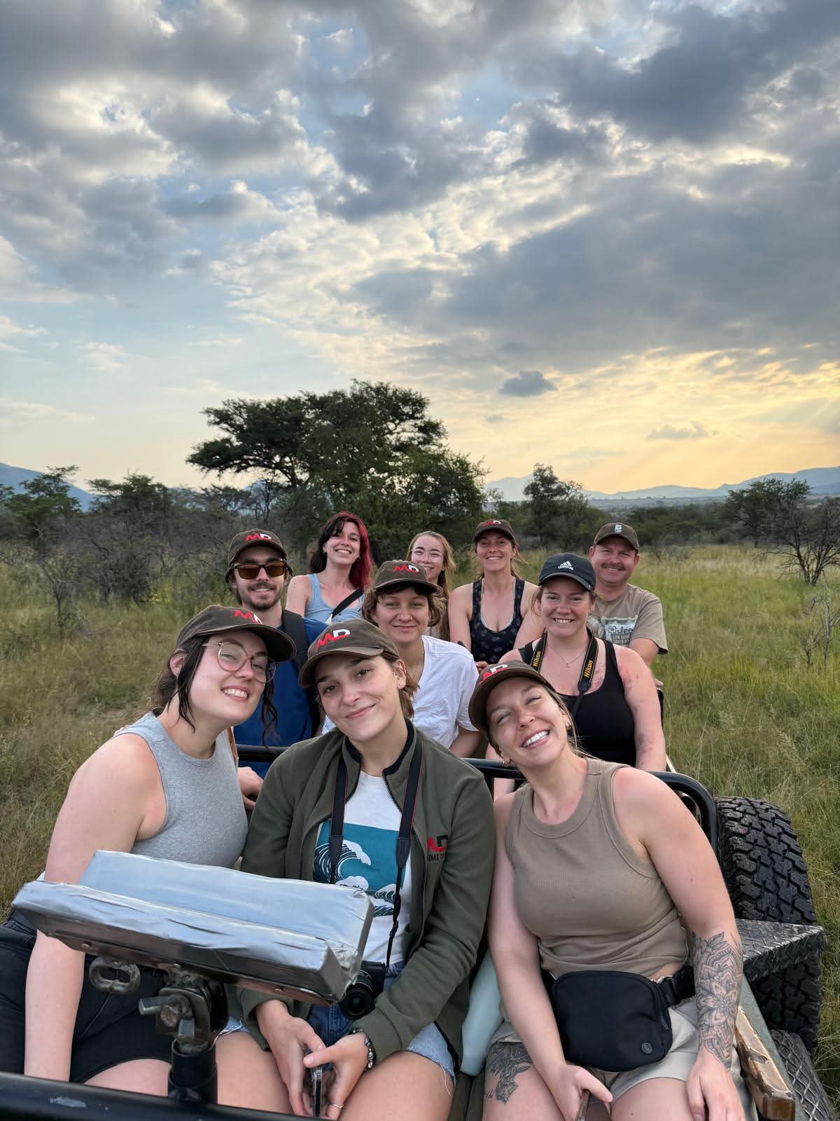 Students Angelo worked with together on an open game-viewing vehicle beneath an evening sky