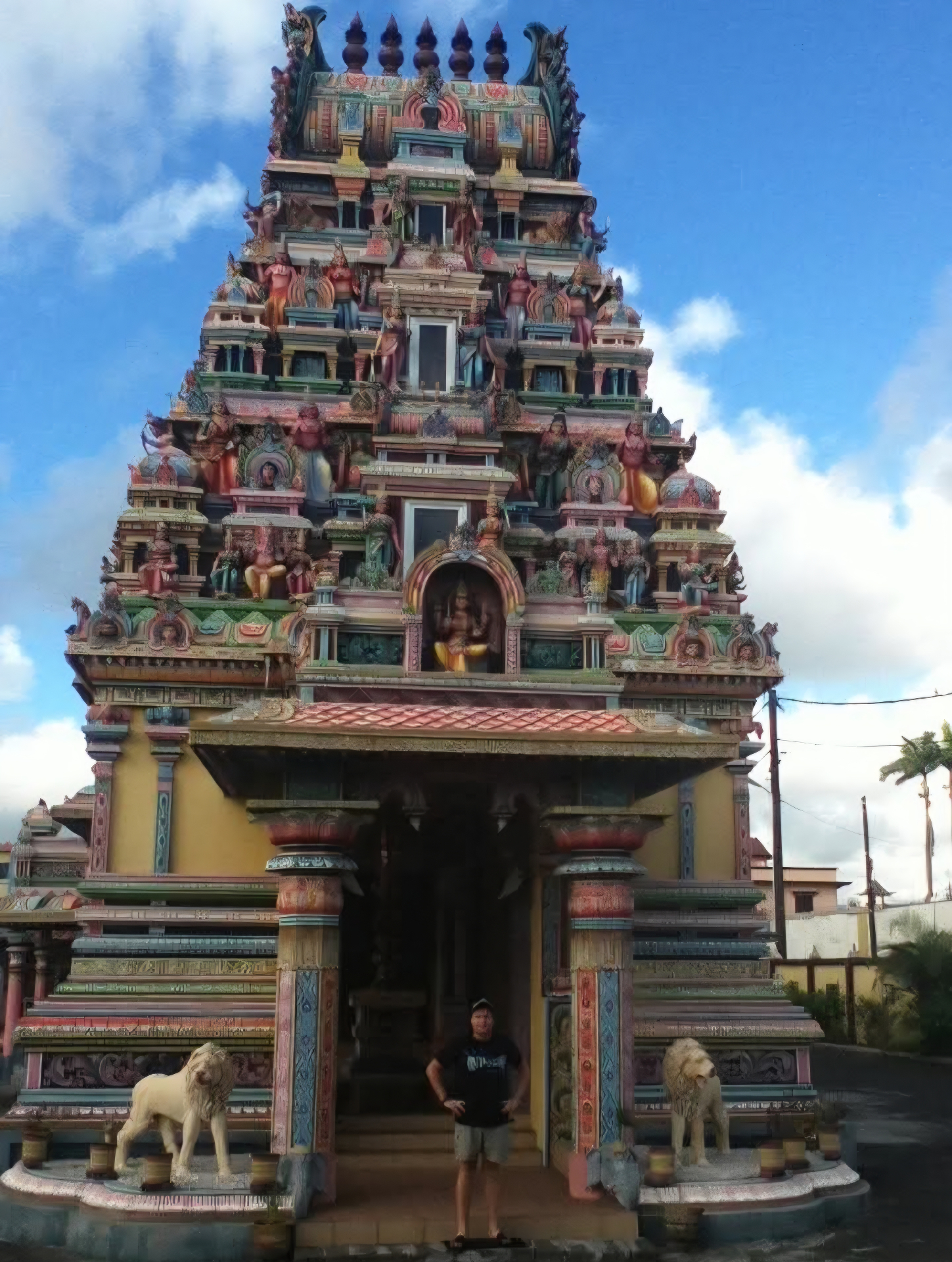 Angelo standing at the entrance to a colorful temple