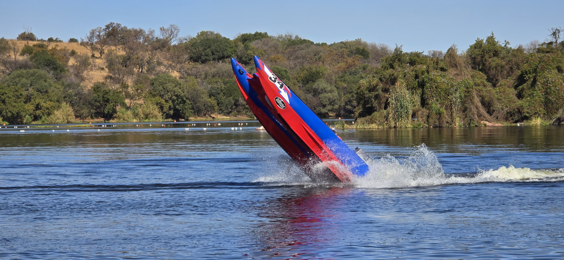 The number 34 boat with its bow high above the lake amid a burst of spray