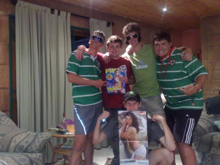 Friends in matching green jerseys posing together in a living room