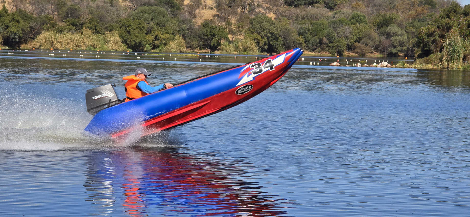 The bow of the number 34 boat lifting above the lake with spray behind it