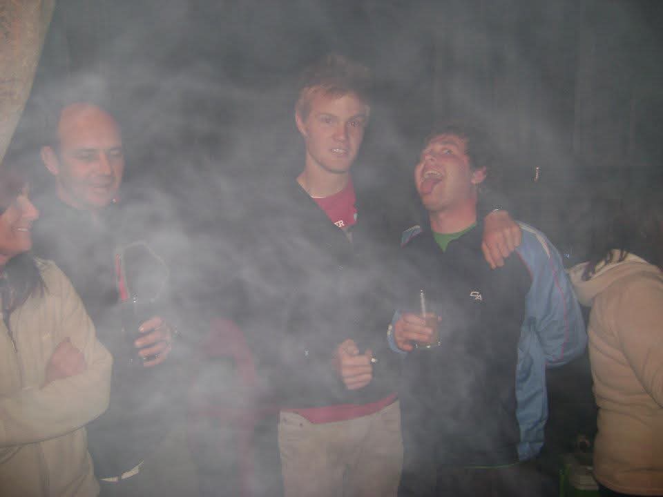 Friends standing together in smoke at night